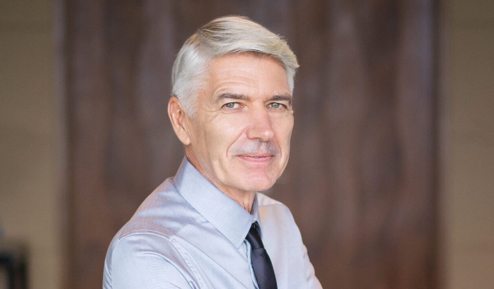 Content Senior Businessman with Arms Crossed