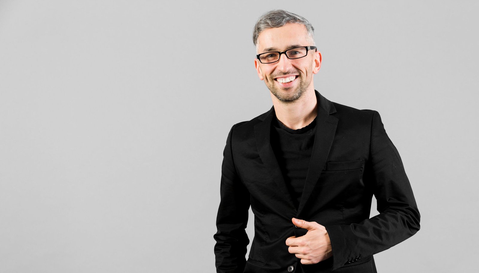 man-black-suit-posing-studio